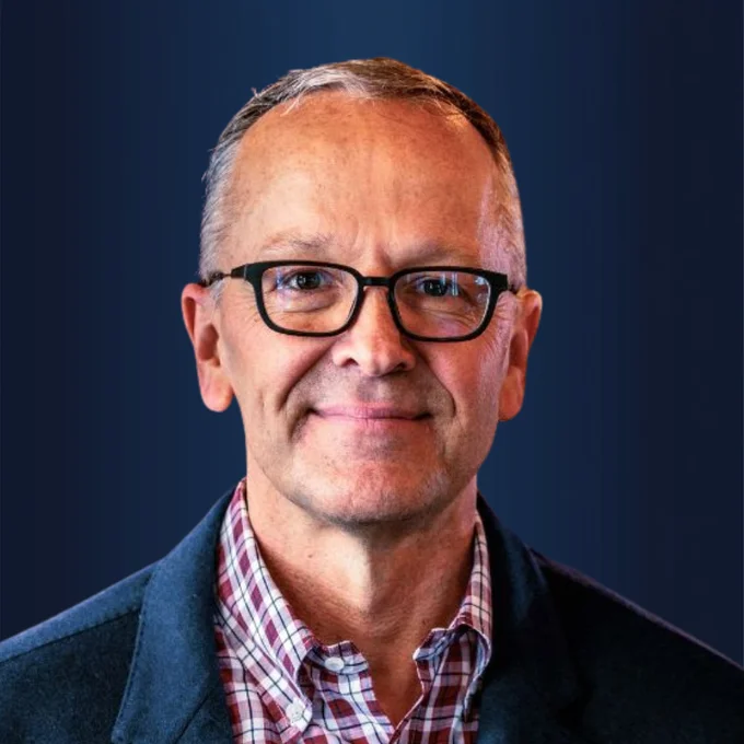 Headshot of a man wearing glasses