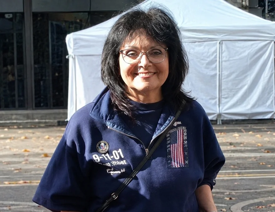 Woman smiling in uniform of 9-11 responder