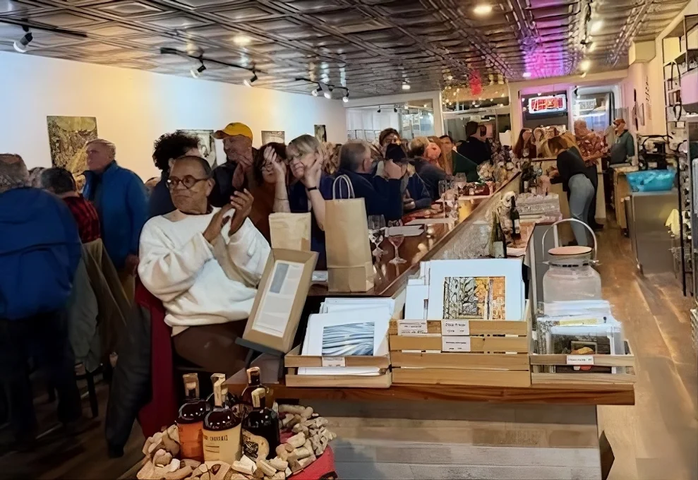 A large group of people gather in a restaurant for an event.