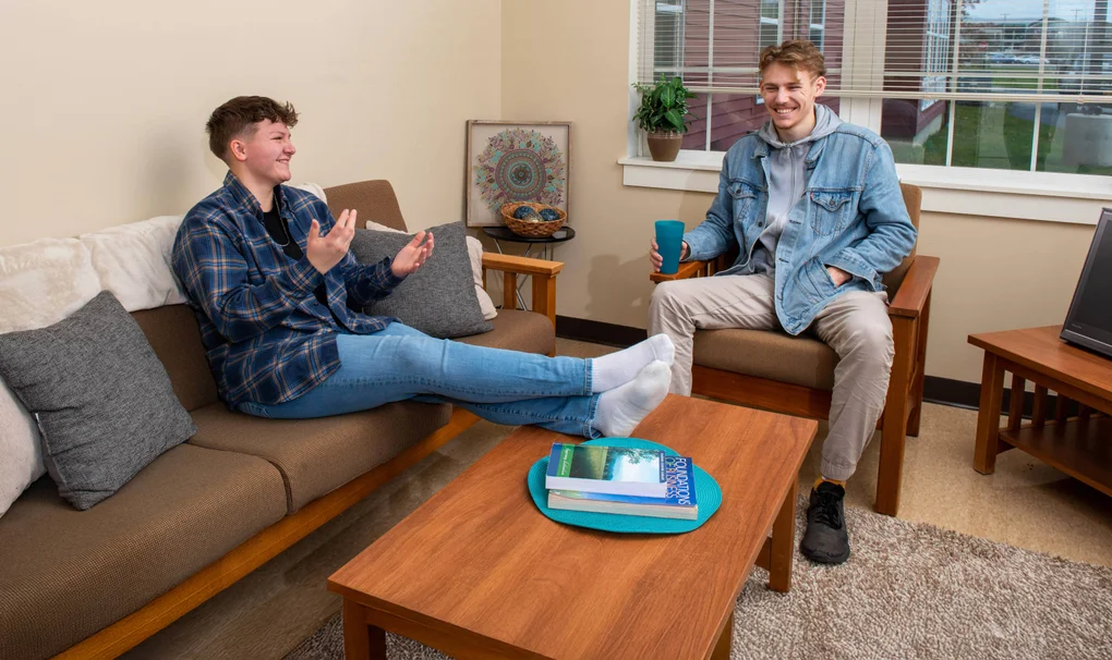 Two students hanging out in the FLCC student housing complex, the Suites at Laker Landing.