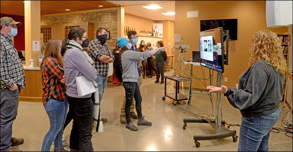 Group looking at an image on TV
