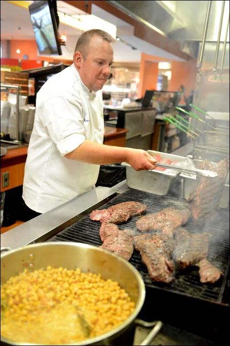 Kurt Hass cooking over a commercial indoor grill