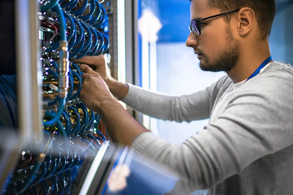 Student working on network switch and cables.