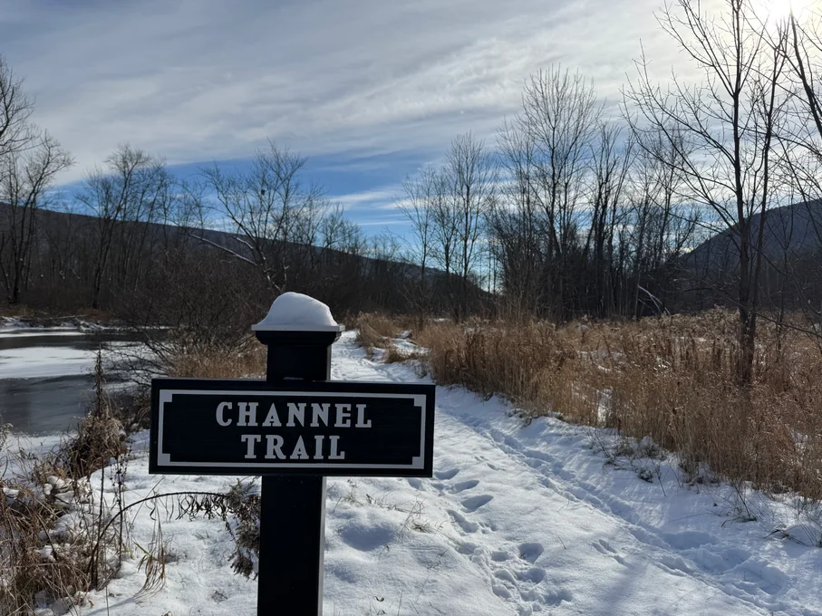 Channel Trail sign in front of snowy trail