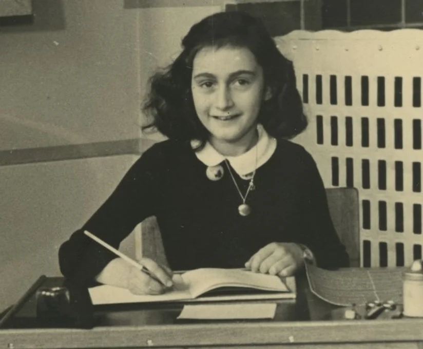 Black and white photo of girl at desk