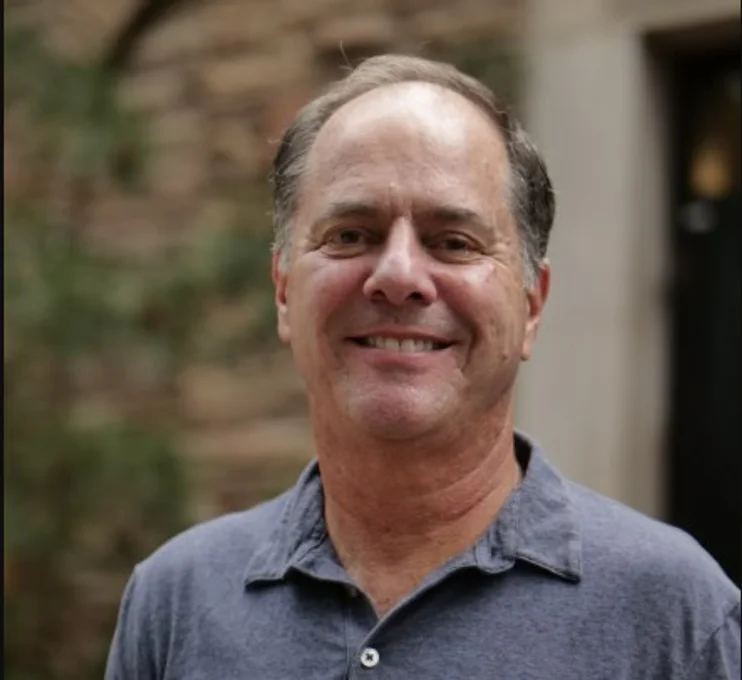 Headshot of man in polo shirt