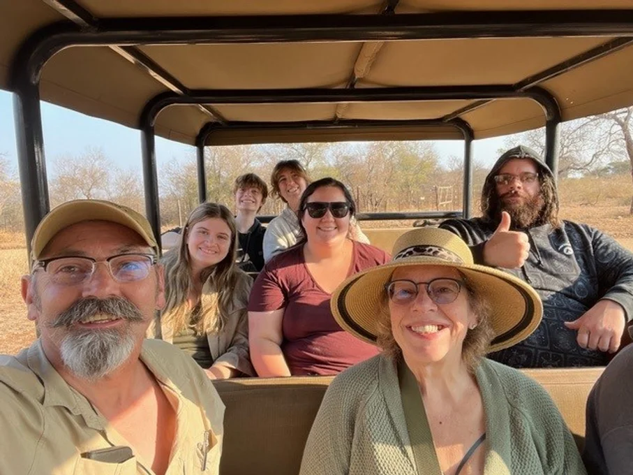 A view of passengers in an open air truck on a game reserve