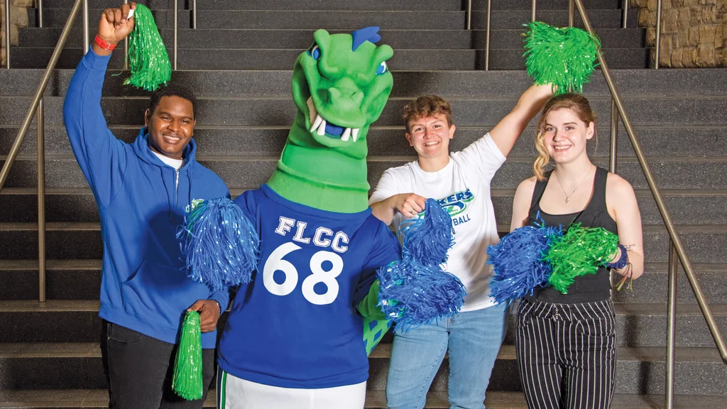 Students and the mascot Flick cheerfully welcome visitors.