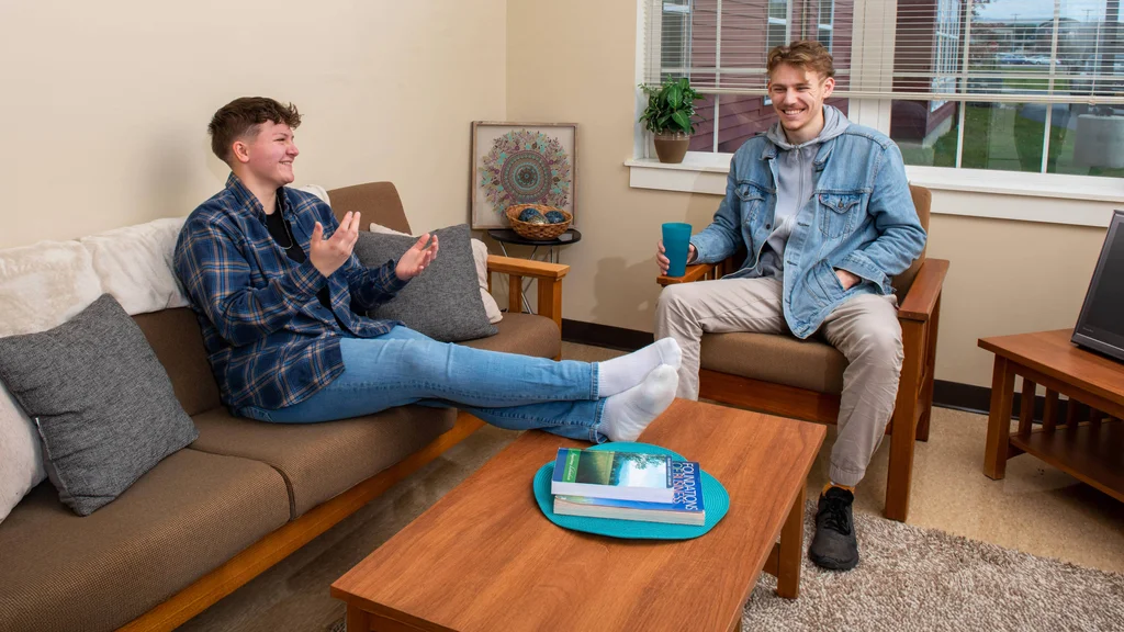 Two students hanging out in the FLCC student housing complex, the Suites at Laker Landing.