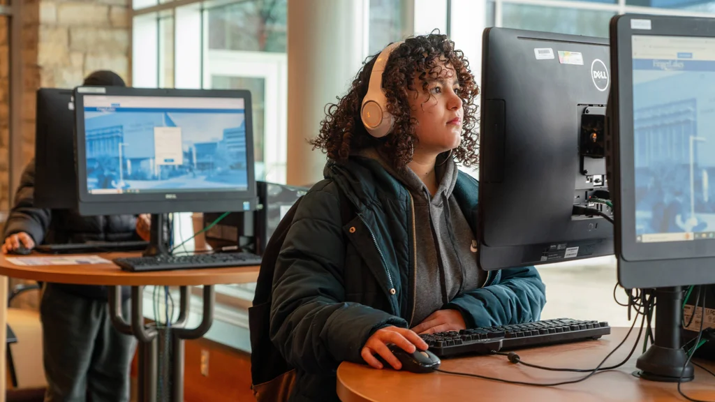 An FLCC student using a computer kiosk in the One Stop Center to register for classes.