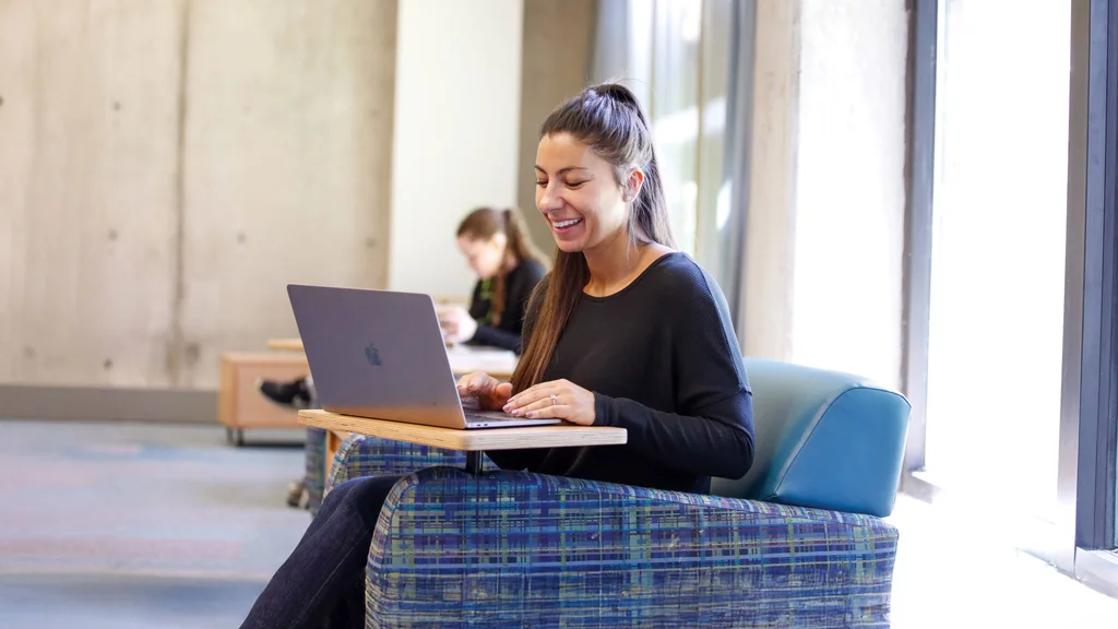 A student using a laptop computer to participate in an online class