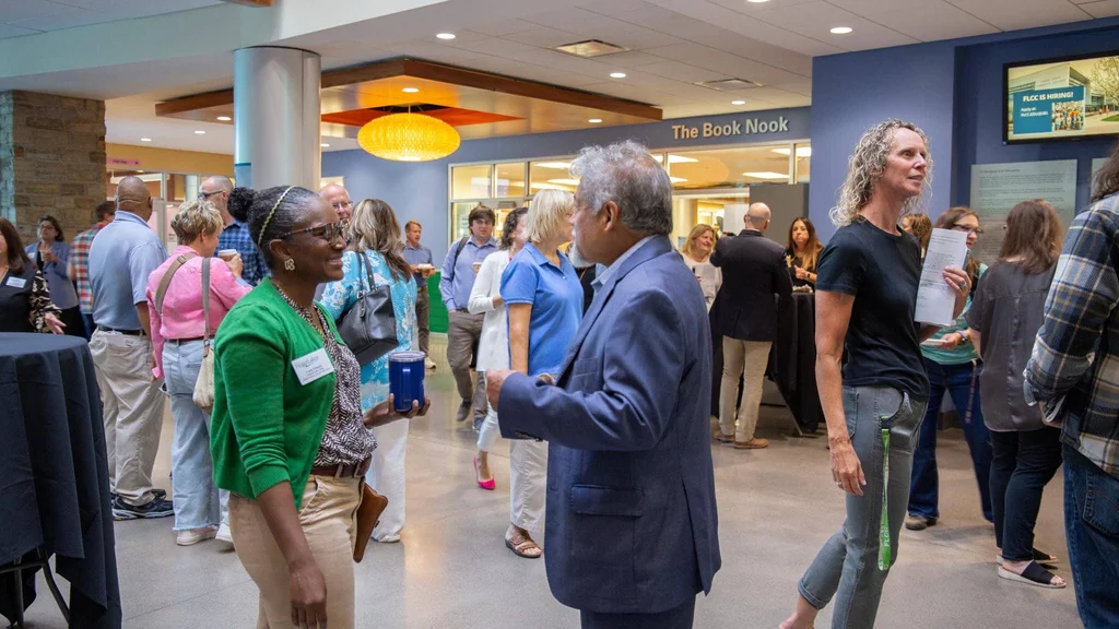 FLCC colleagues greet one another in the Atrium at the start of the semester.