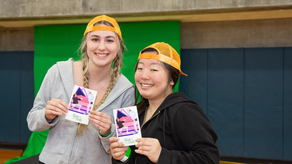 Two students enjoy May Day in the FLCC gymnasium
