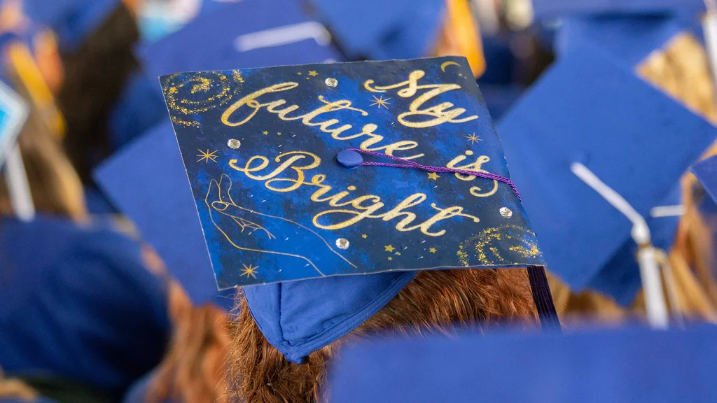 FLCC graduate with the message difficult roads often lead to beautiful destinations printed on graduation cap