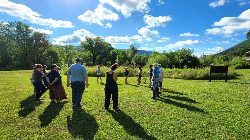 A group of community members standing in a circle at Muller Field Station.