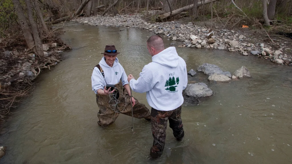 Students wading in stream