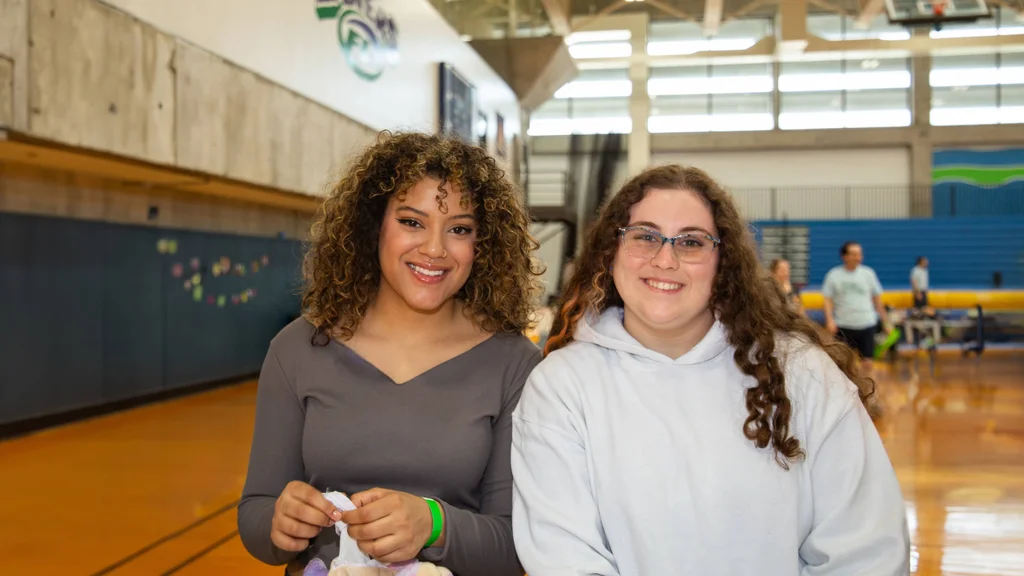 Two students in the FLCC gym for a May Day celebration