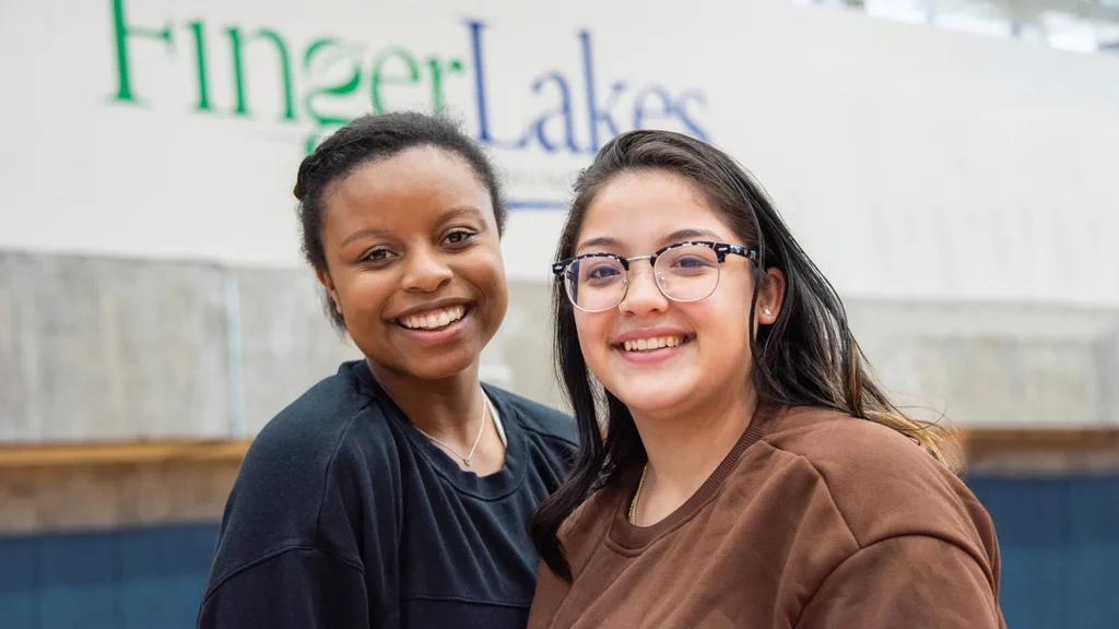 Two students participating in May Day activities in the FLCC gym.