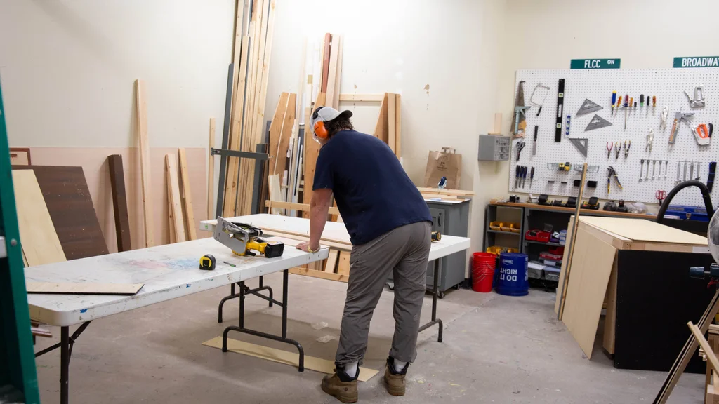 Student works on constructing a theatre set for an FLCC performance.