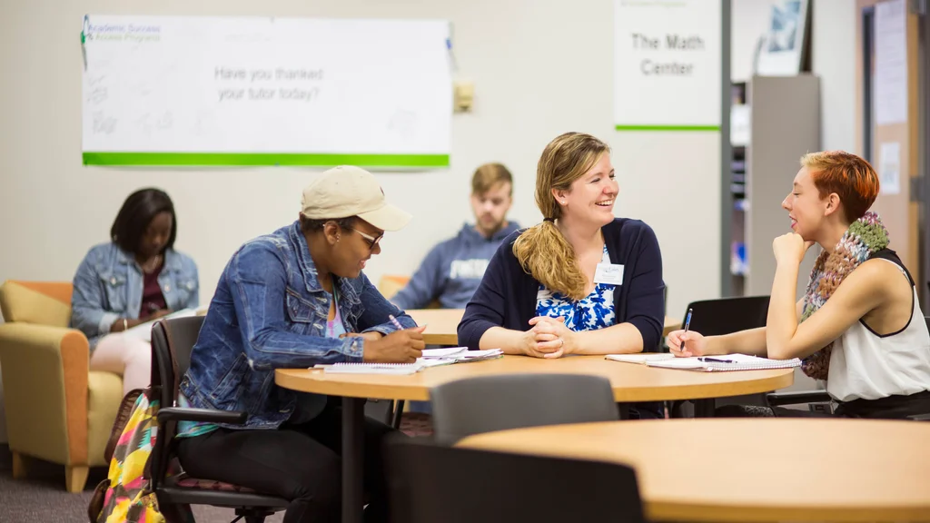 Staff member and students in the Academic Success and Access Programs center.
