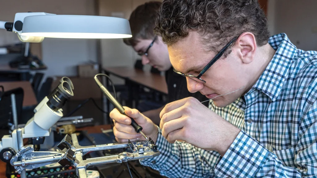 Smart Systems Technologies student building an electronic device at FLCC.