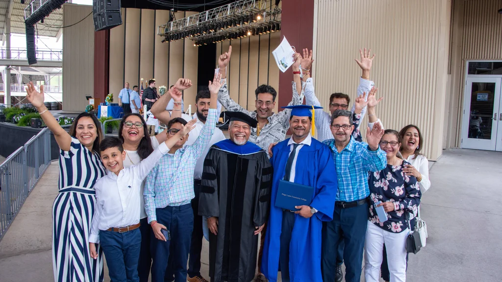 A group of FLCC graduates, faculty, and community members celebrating at commencement.