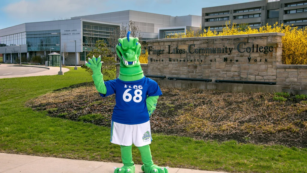Flick, the FLCC mascot, waving to new students in front of main campus.