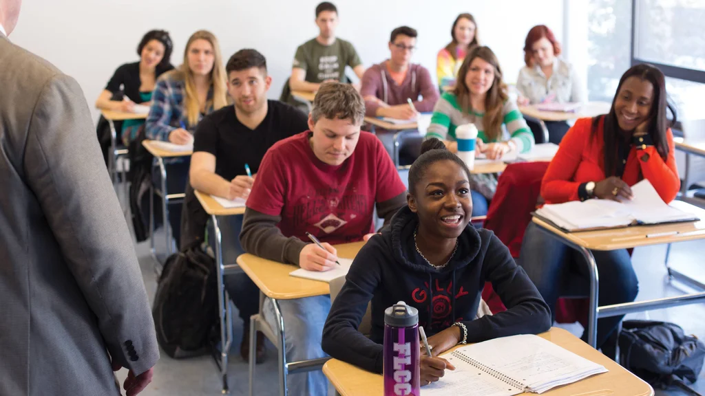 A classroom full of students, taking notes and engaging in class discussion.