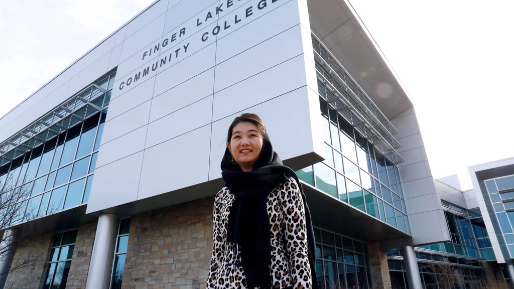 FLCC student near the main building on the Canandaigua campus.