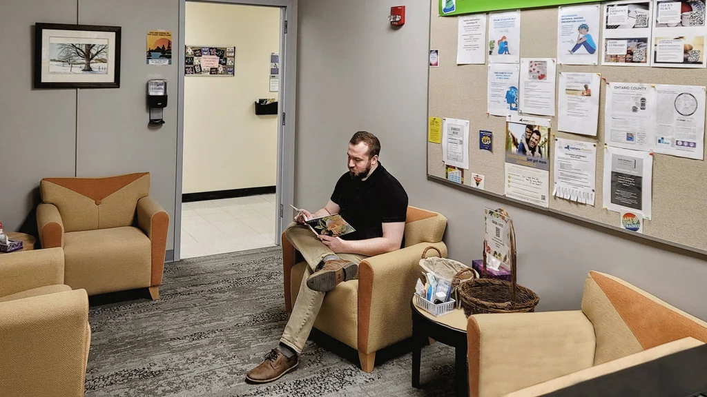 A student sitting in the Center for Student Well-Being, waiting for an appointment.