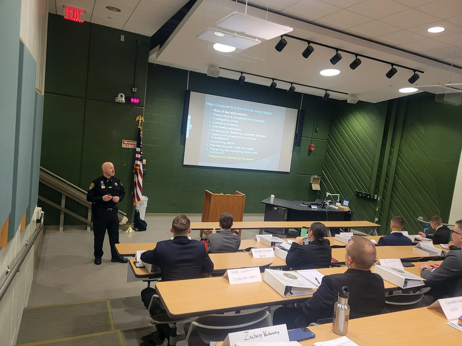 Instructor standing in front of lecture hall