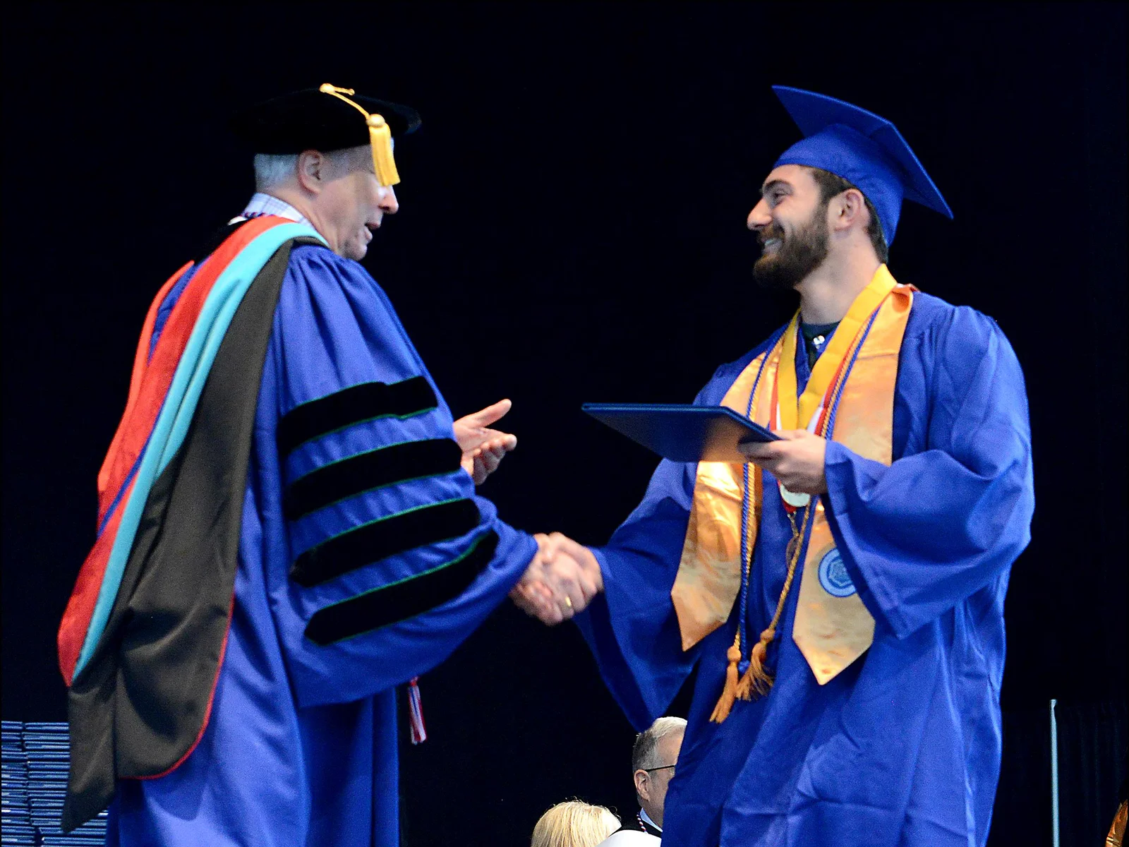 Daniel DiSalvo receives diploma from college president