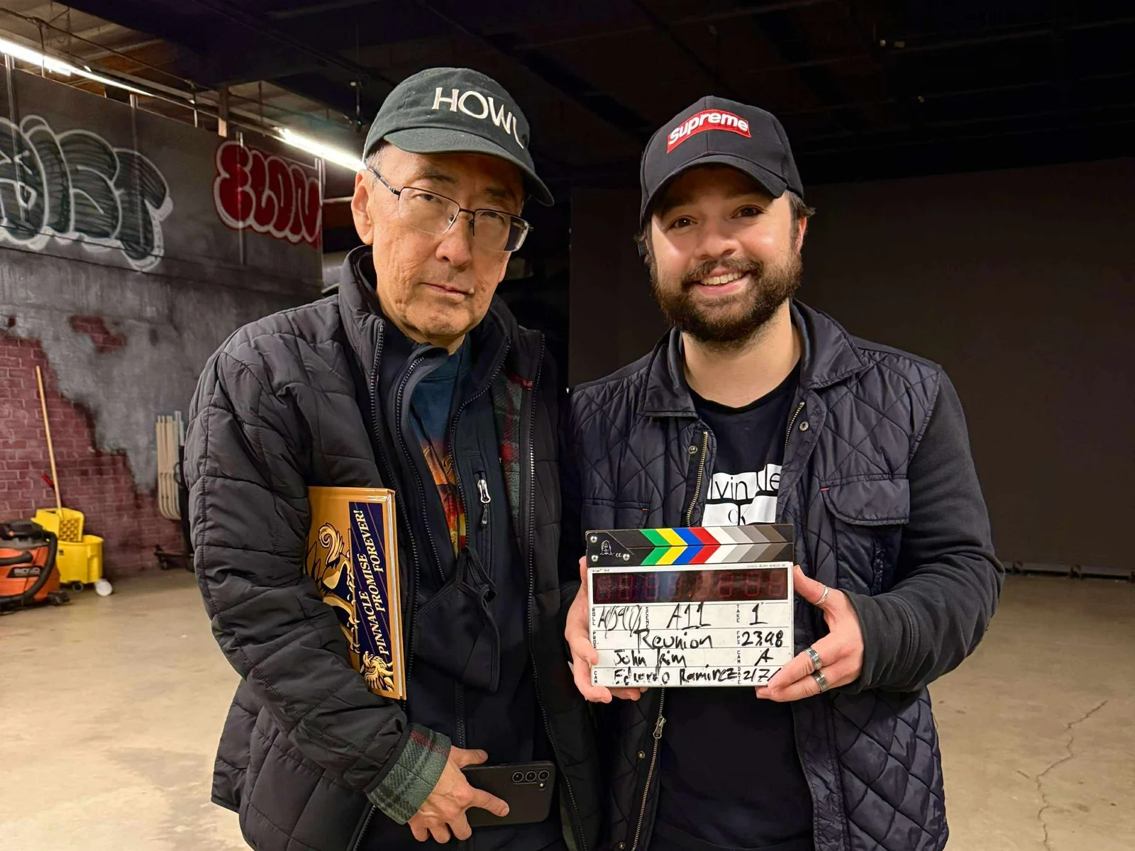 John W. Kim standing next to Noah Pitifer on the set of 'Reunion'