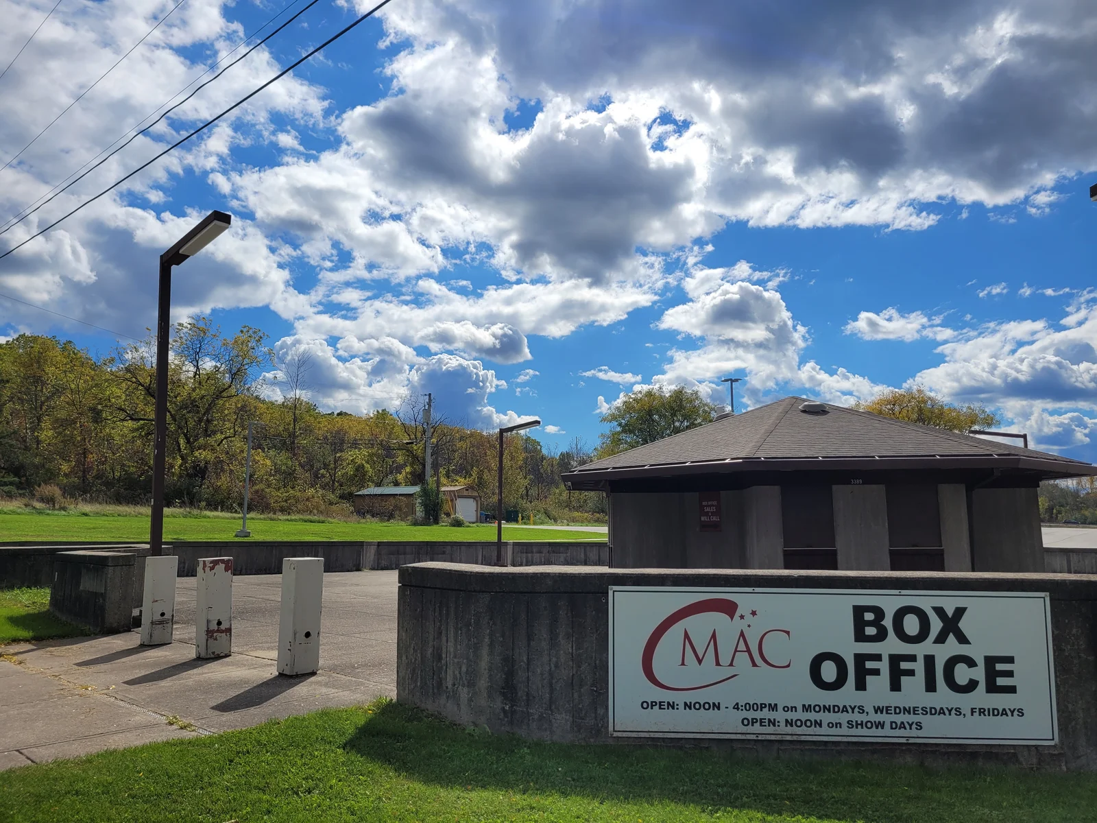 Landscape view of the Constellation Brands Marvin Sands Performing Arts Center (CMAC) box office on a cloudy, blue-sky day.