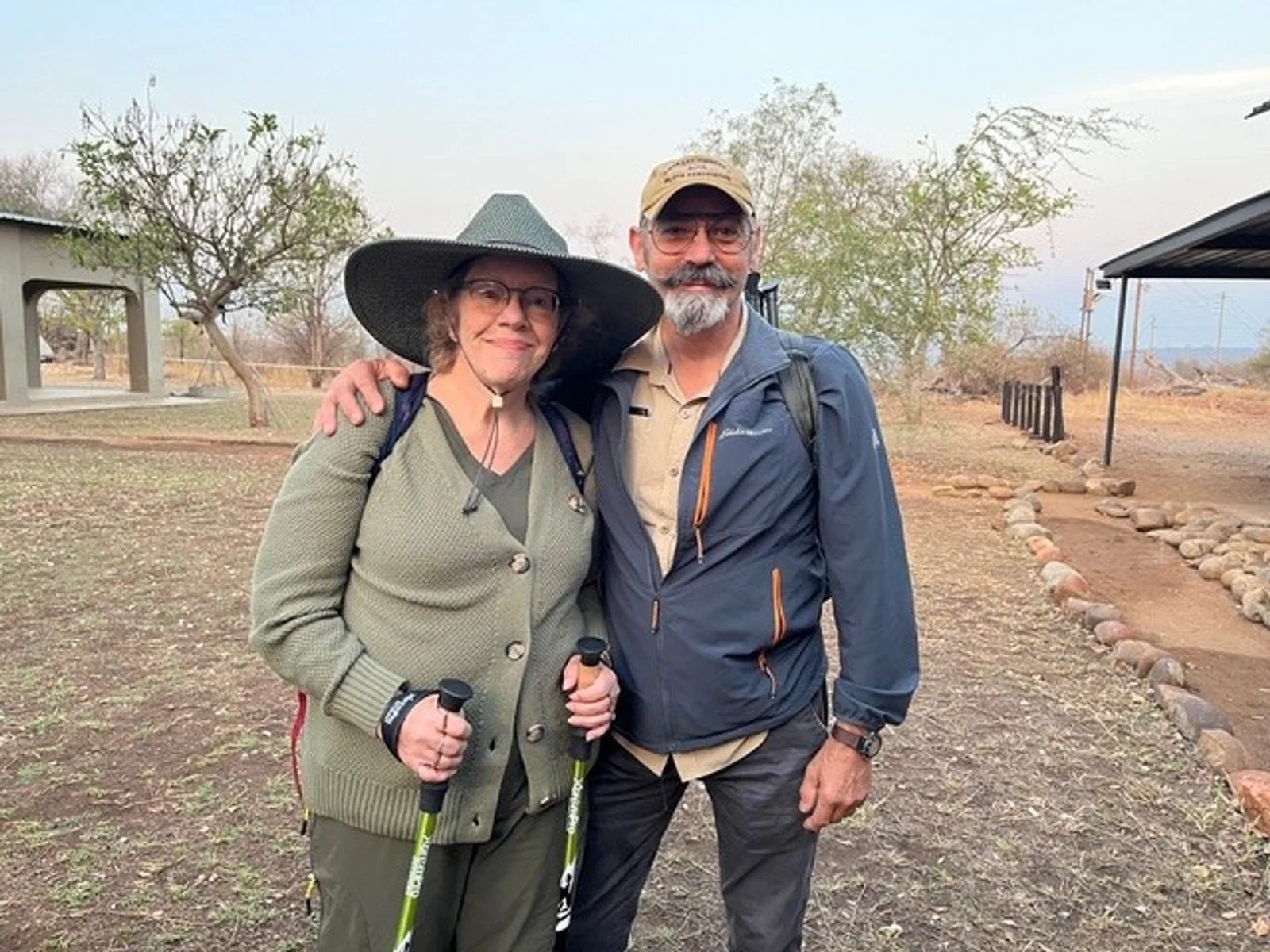 Older man and woman posing outdoors in South African reserve