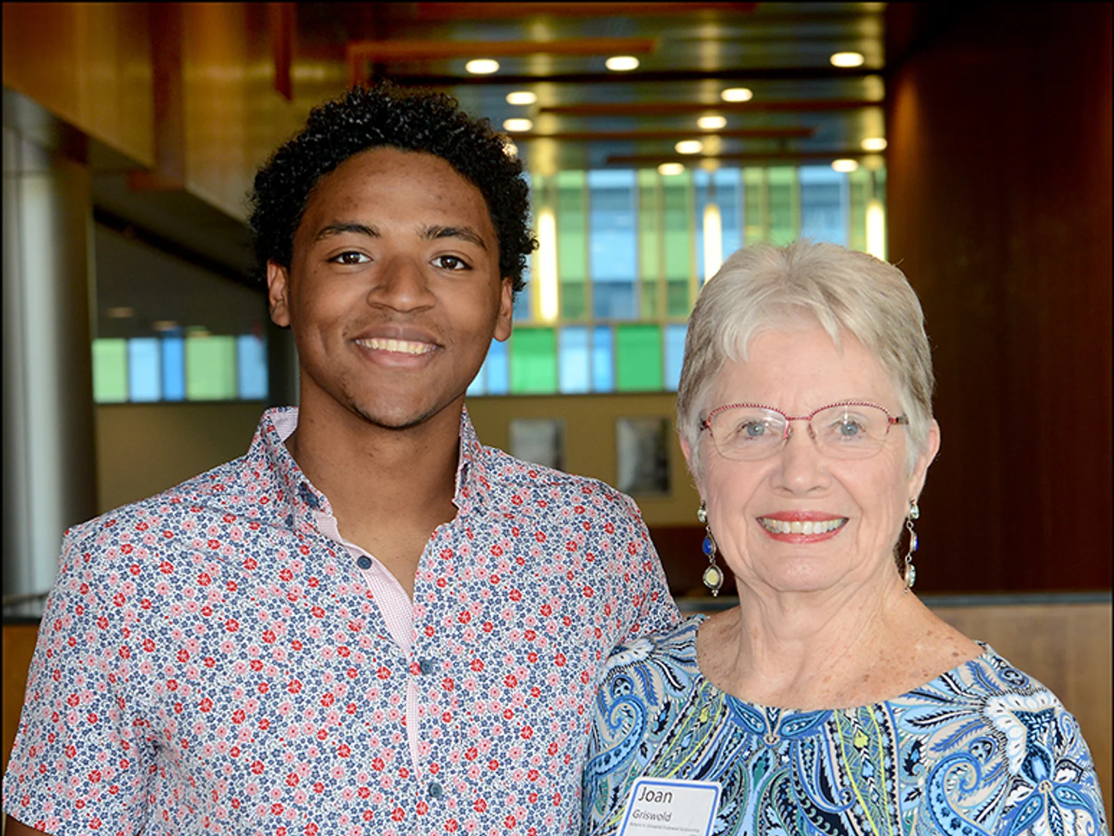 A young man posing with an older woman