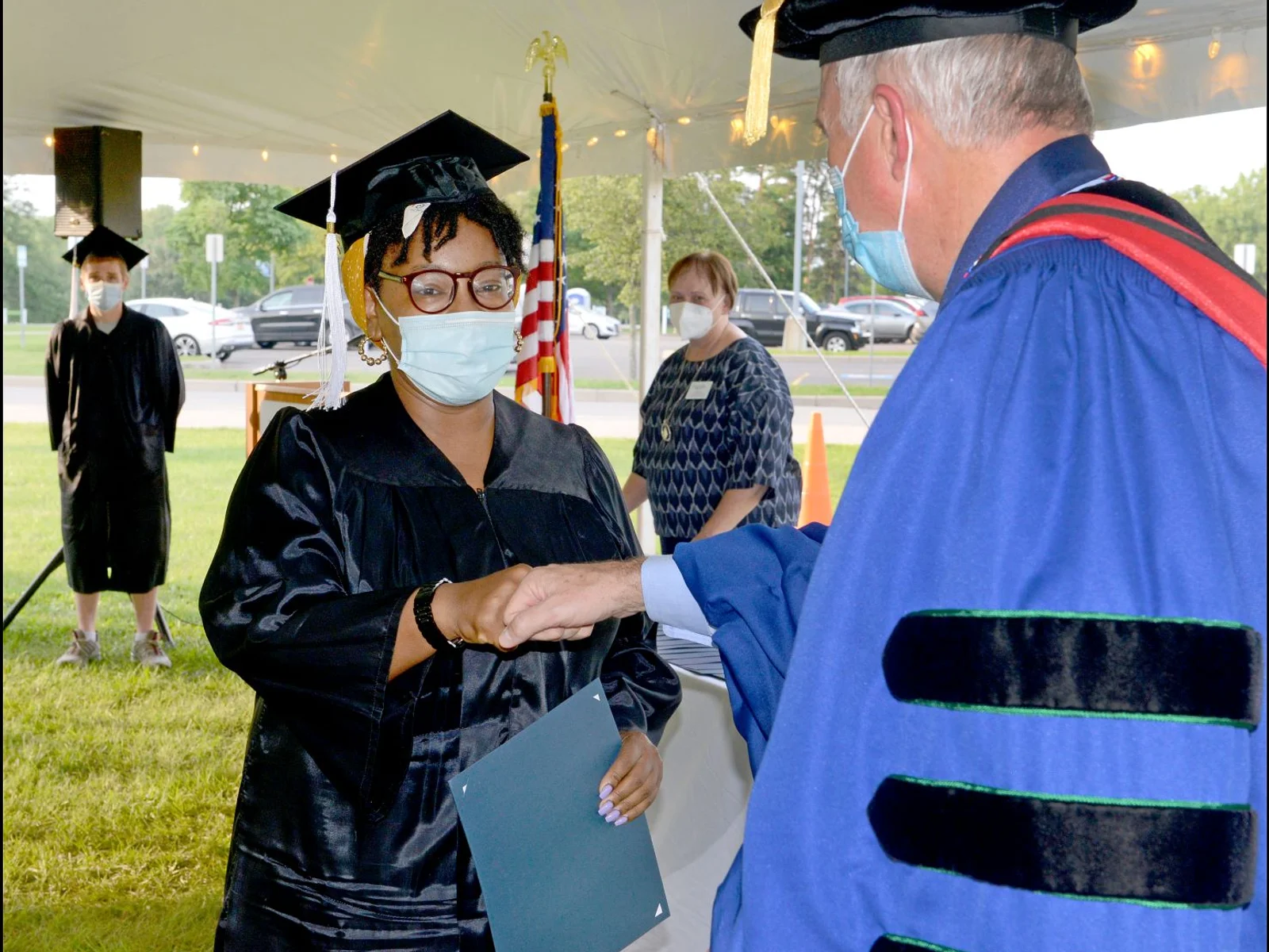 Grad fist bumps president