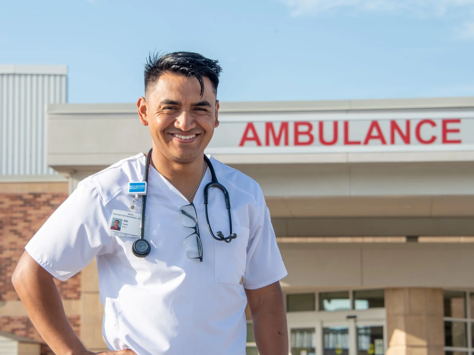 Nurse standing outside hospital emergency entrance
