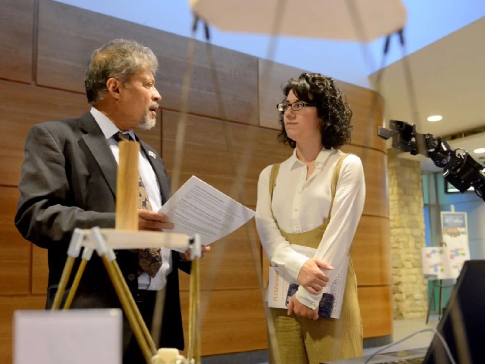 Man speaking to woman at trade show