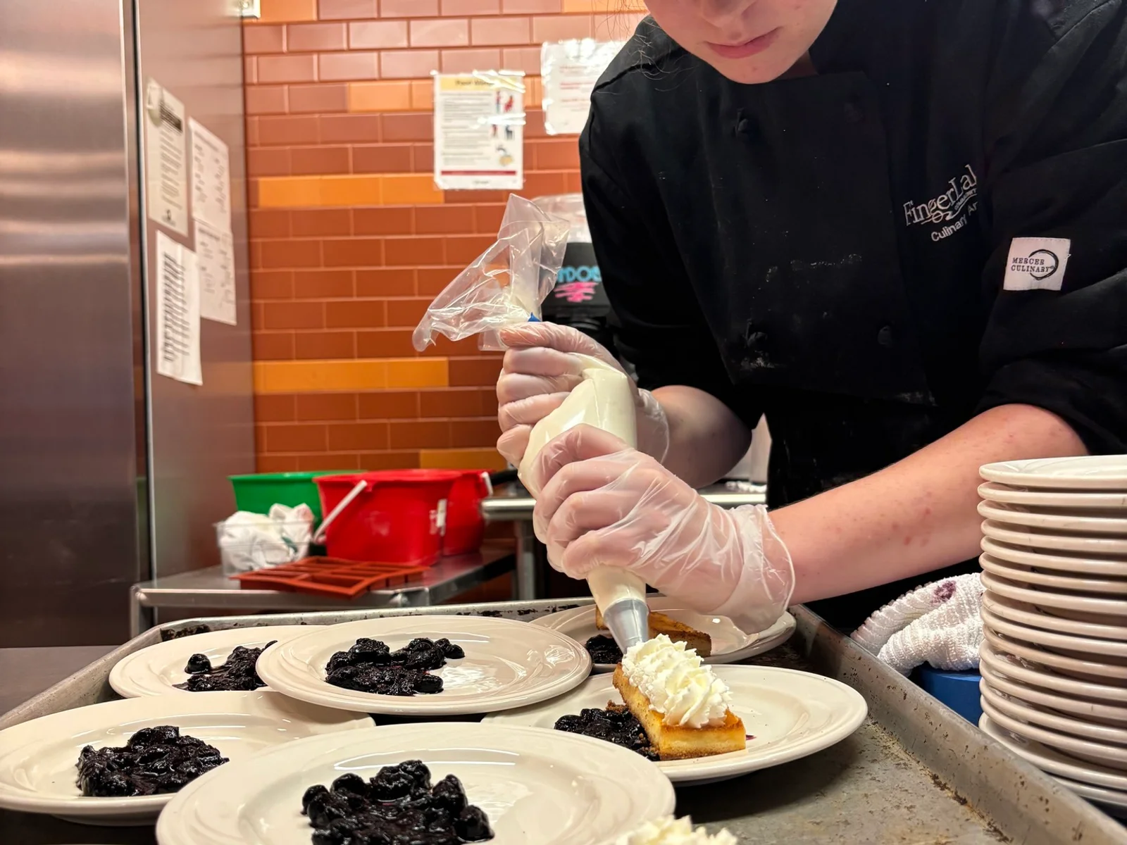 A slice of pie drizzled with chocolate and topped with a whipped cream.