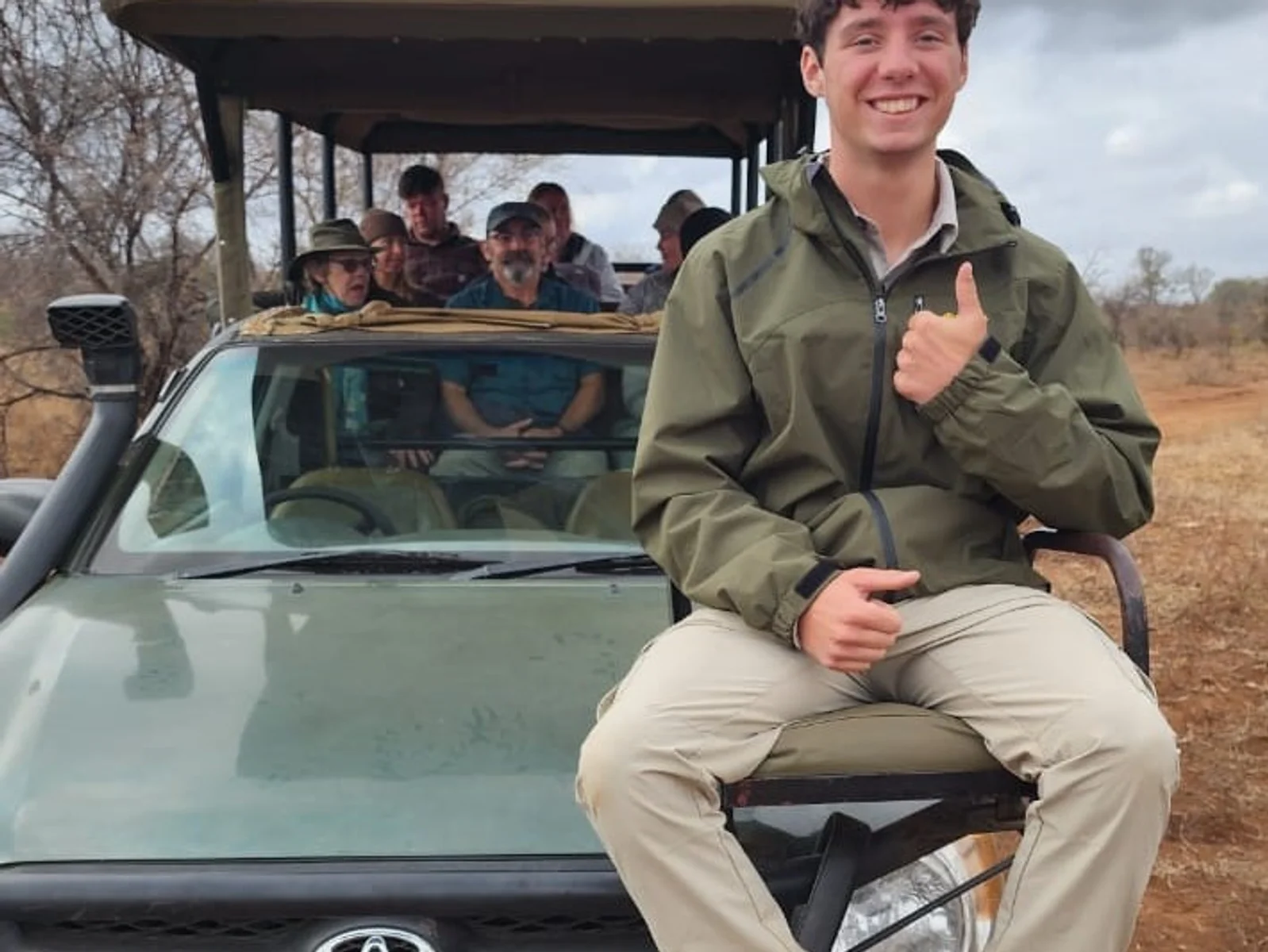 A view of passengers in an open air truck on a game reserve