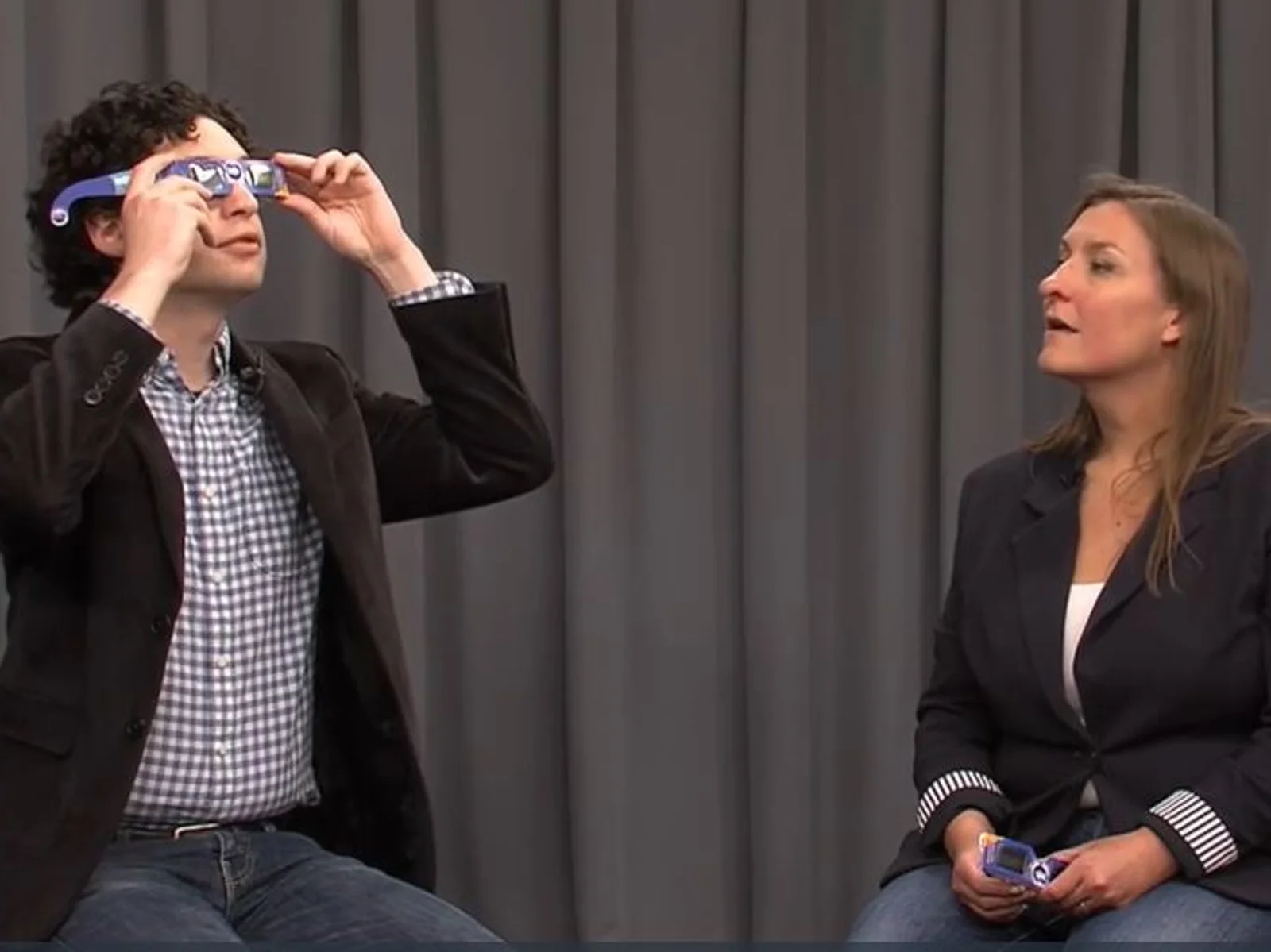 Man and woman on TV set