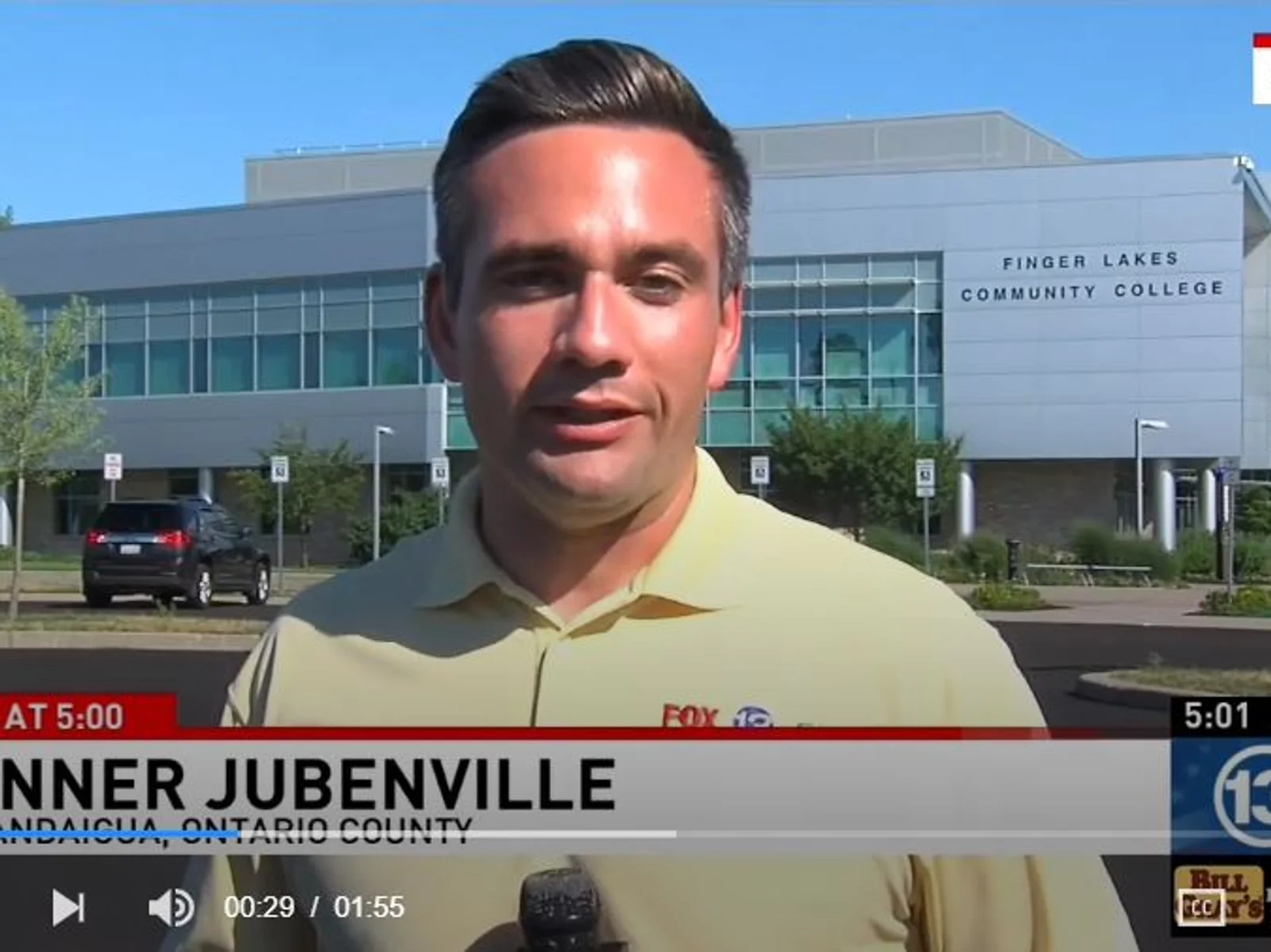 Reporter speaking on camera in front of FLCC main campus