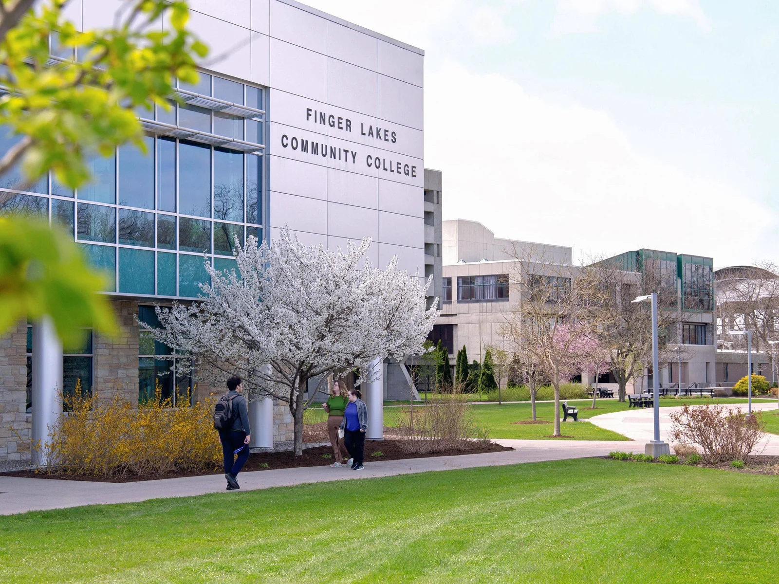 FLCC campus in the spring with flowering trees and shrubs.