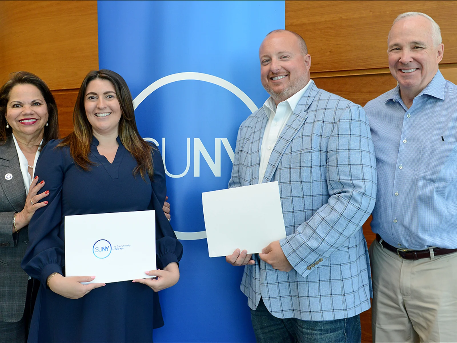 Two women and two men posing at an award event