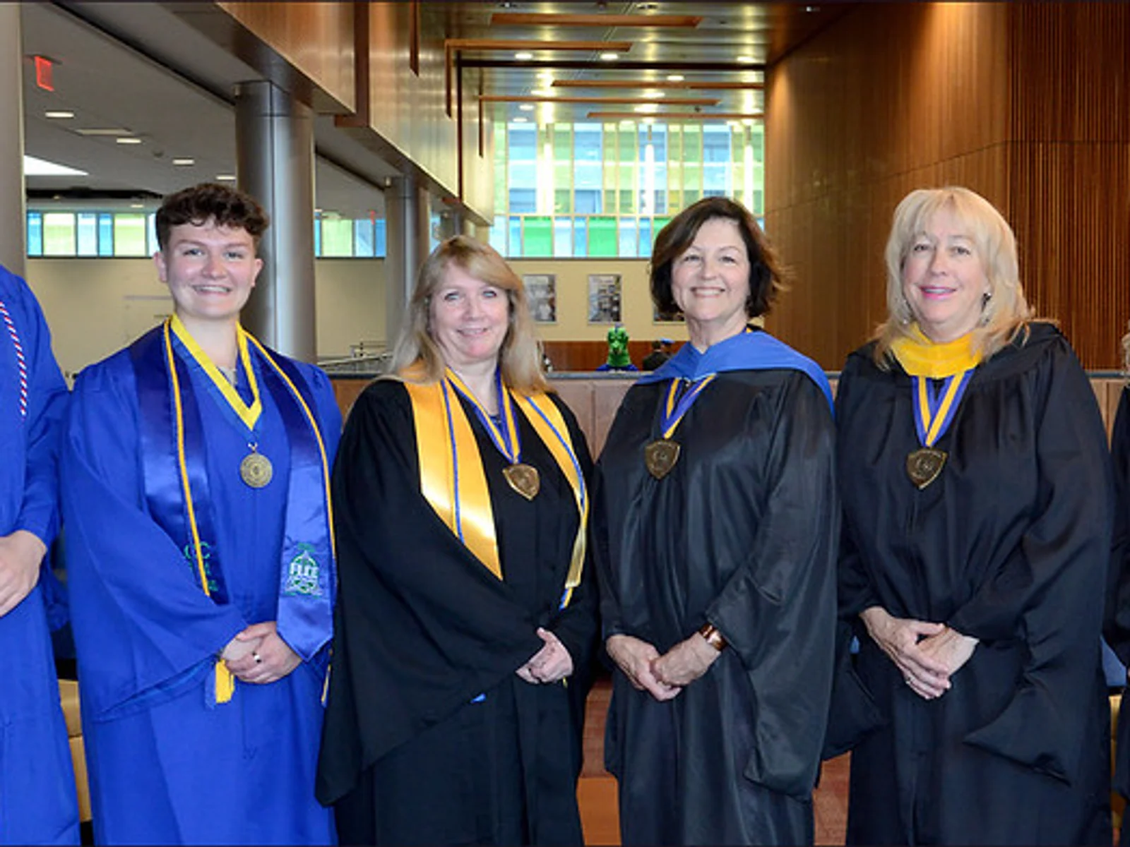 1 man, 5 women in academic regalia