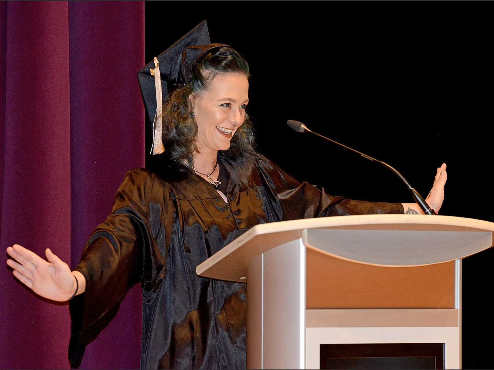 Graduate speaking at podium