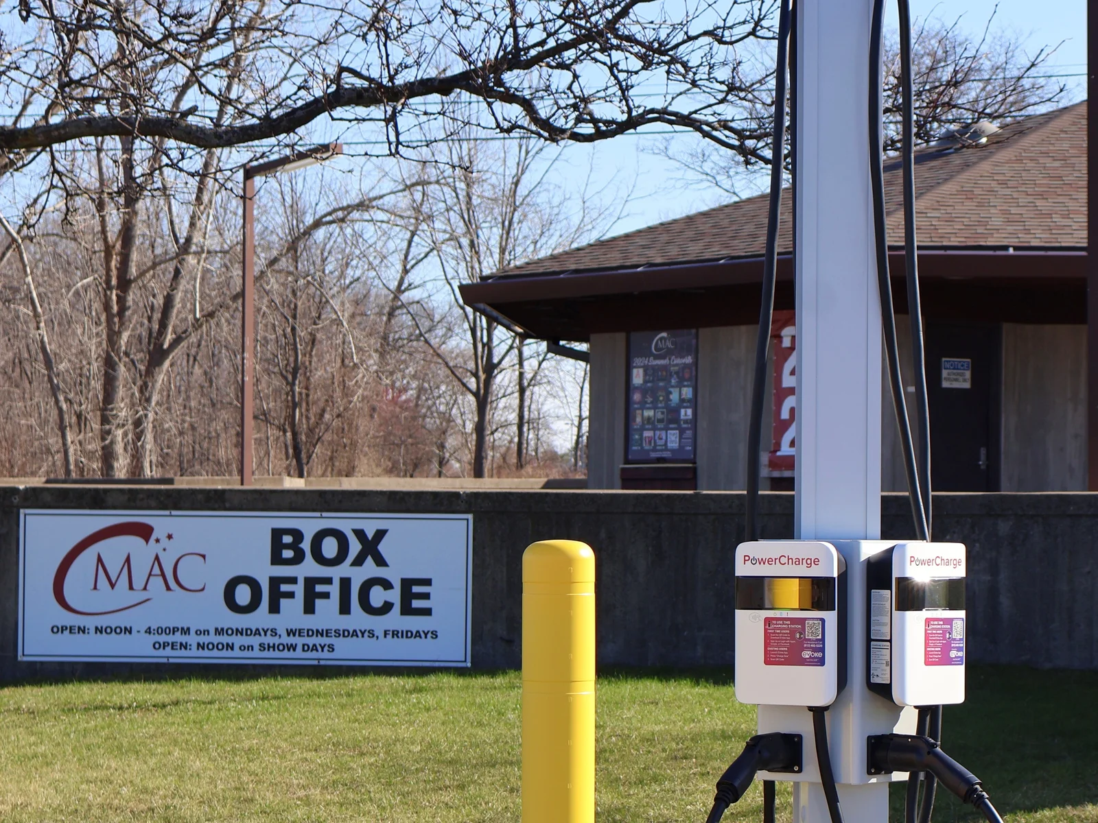 EVoke electric vehicle charging station located in the FLCC parking lot with the CMAC box office in the background.