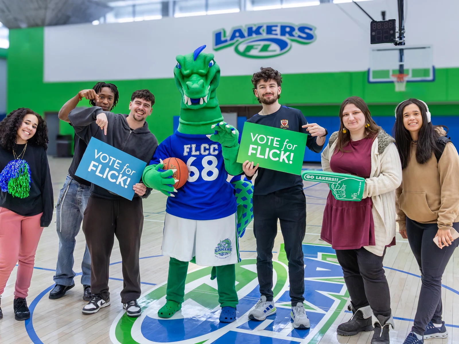 Students pose with Flick while holding “Vote for Flick” signs.