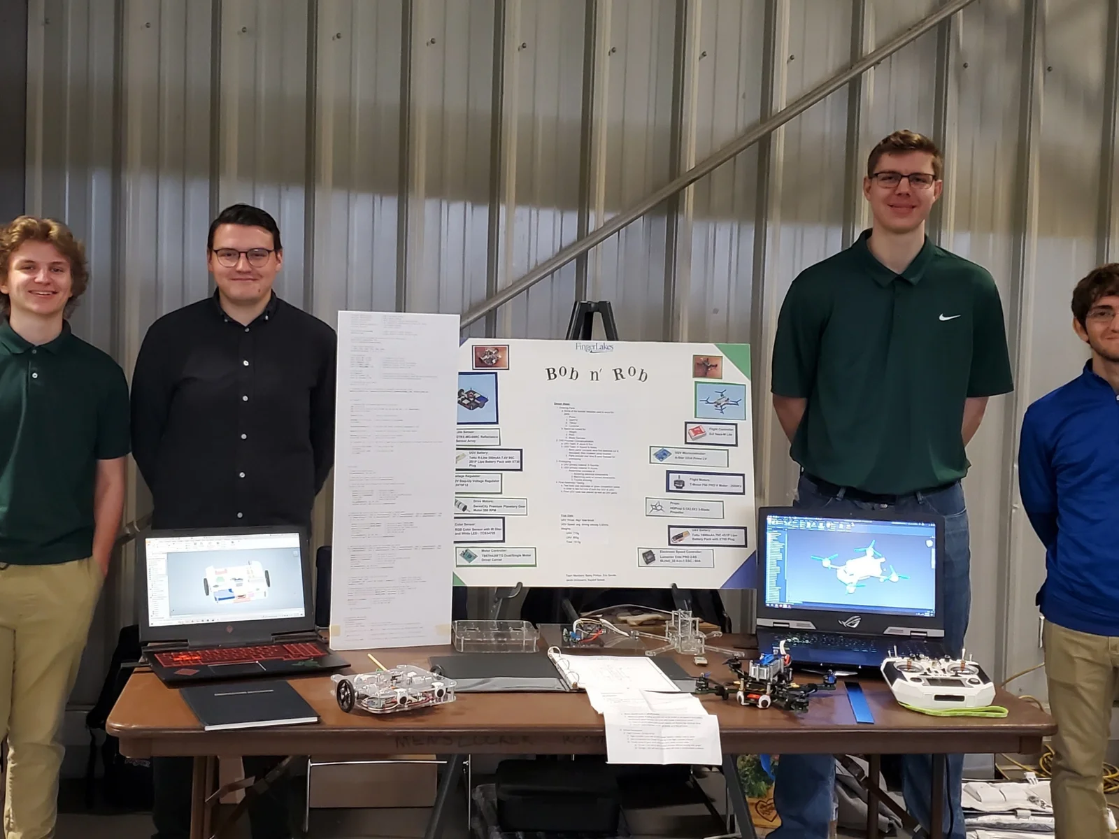4 students posing with presentation materials